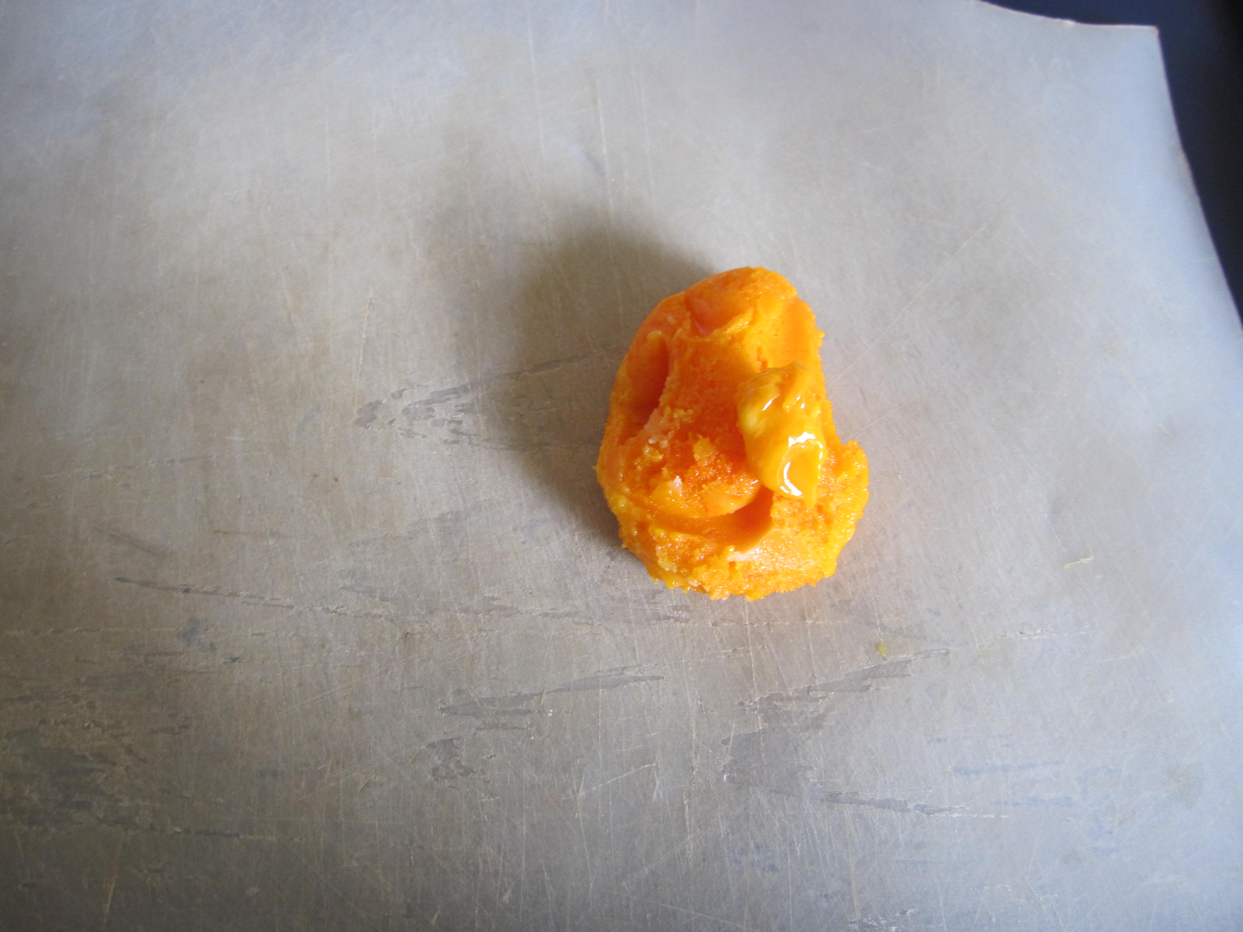 stiff yellow ball on white plastic chopping board