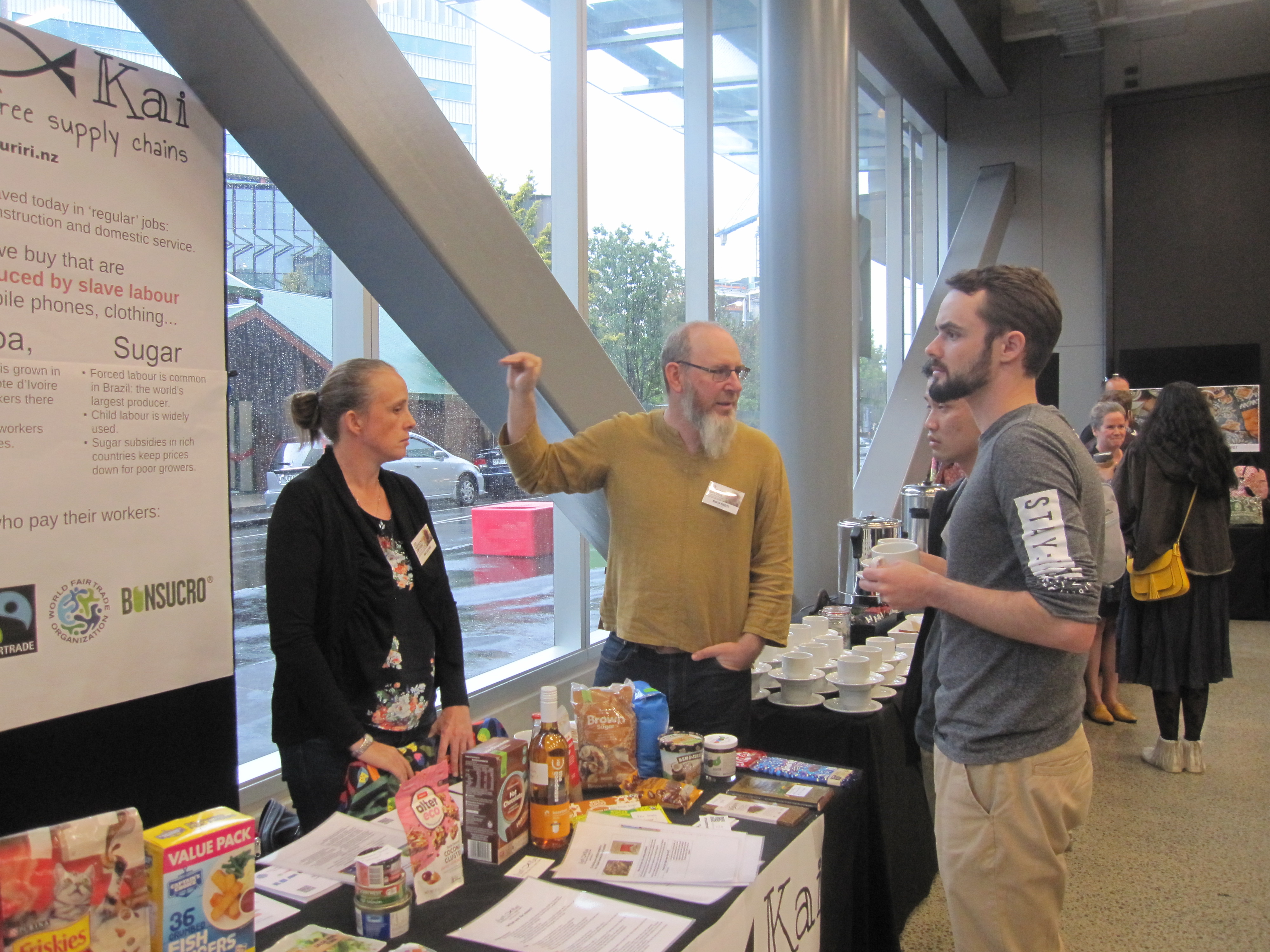 Martin talking to two young men at our table. Anna is listening.