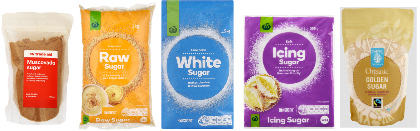 Five bags of sugar products. The first bag is Trade Aid Muscovado sugar in a clear bag with a red label. The second bag is Countdown own brand Raw sugar in a yellow orange bag. The third bag is Countdown own brand white sugar in a blue bag. The fourth bag is Countdown own brand icing sugar in a purple bag. The fifth bag is Chantal Organics Organic Golden Sugar in a light brown bag.